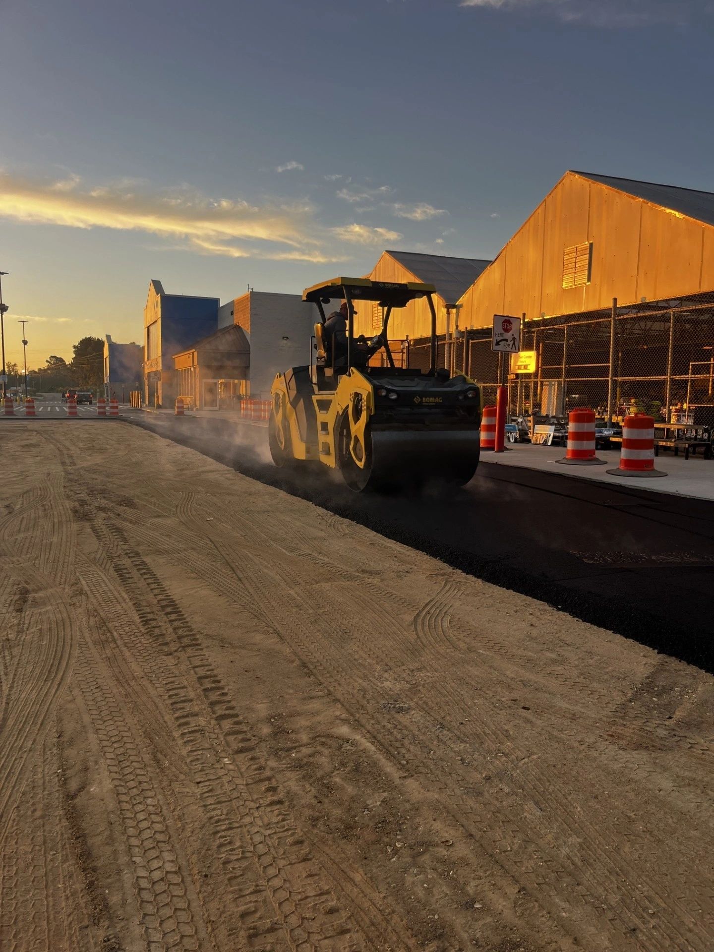 Roller compacting fresh asphalt on a paving job
